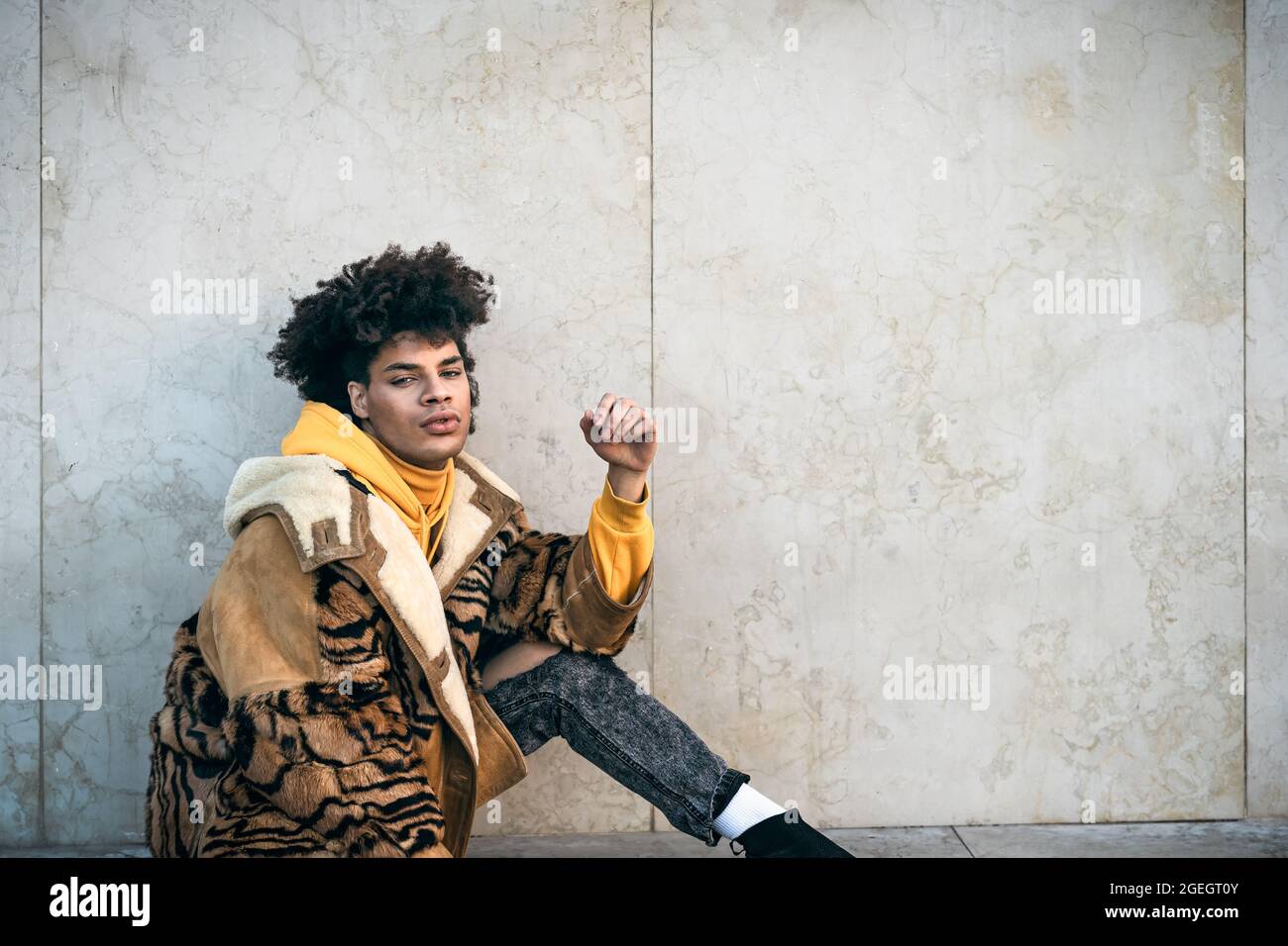Young Afro gay man posing while looking into the camera Stock Photo