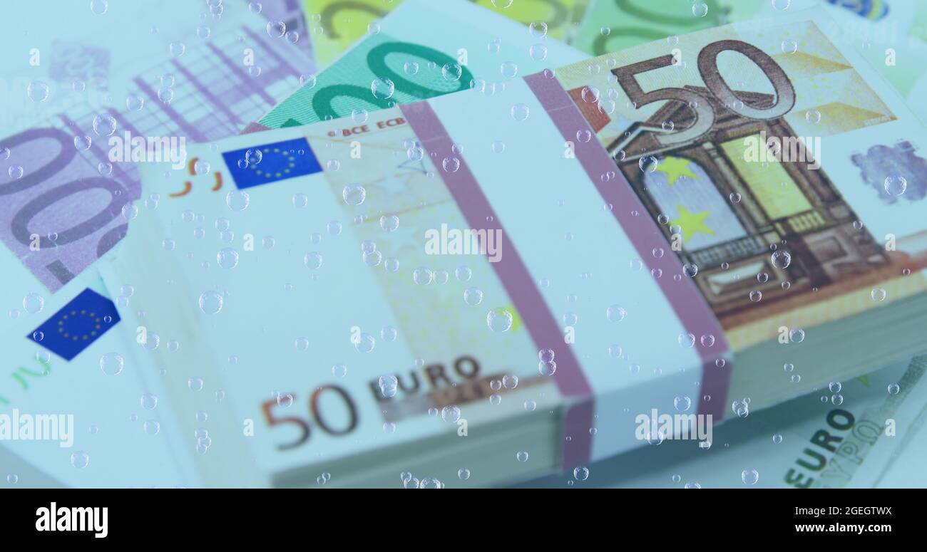 Image of numbers changing and bubbles over stacks of euro currency