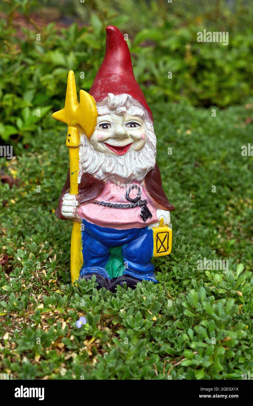 Old garden gnome in home garden Stock Photo