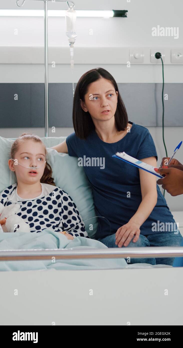 African american pediatric nurse explaining recovery treatment to