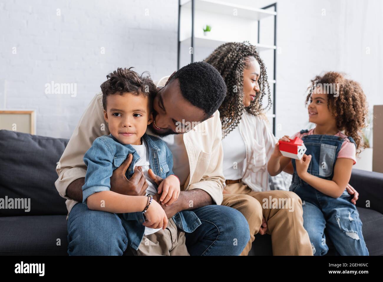 happy african american family sitting on sofa in new apartment Stock ...