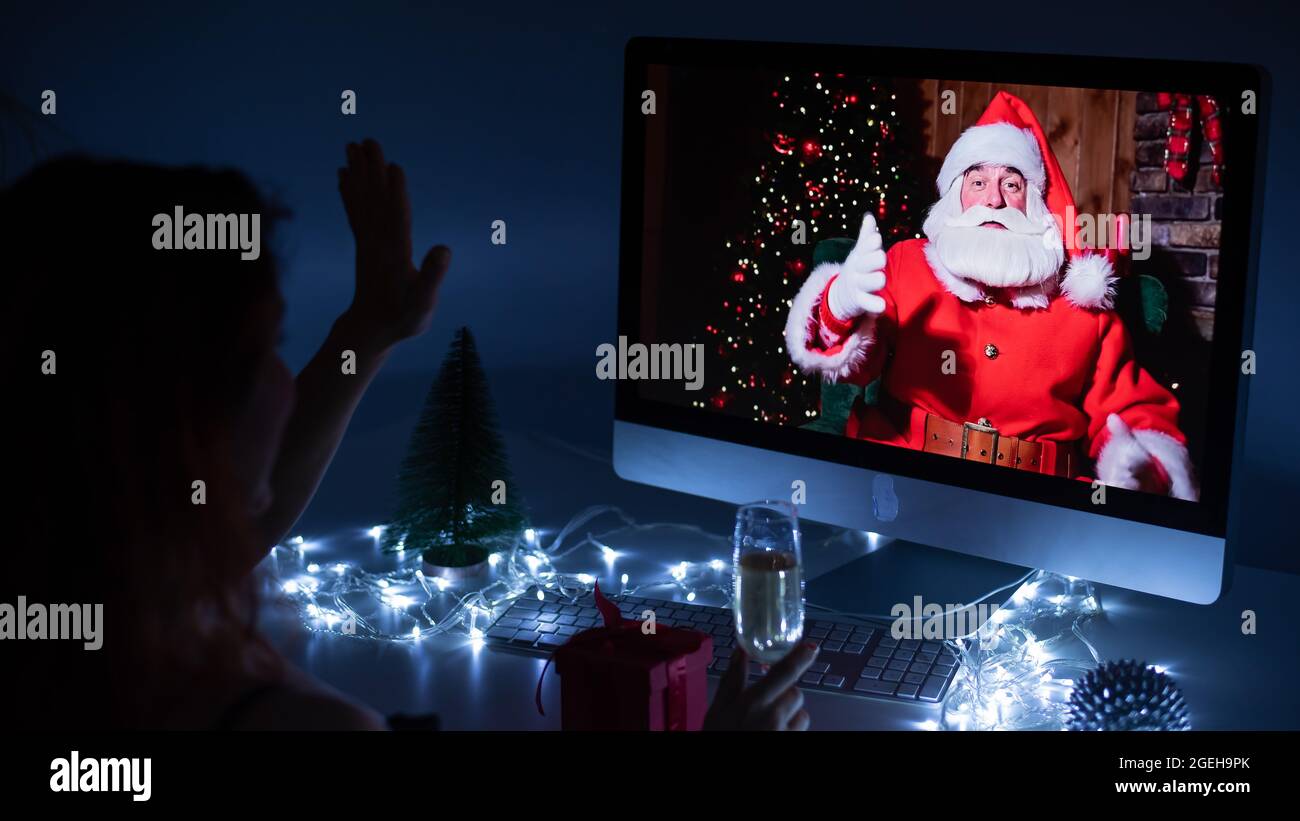 Woman remotely talking with Santa Claus on a video call on your ...