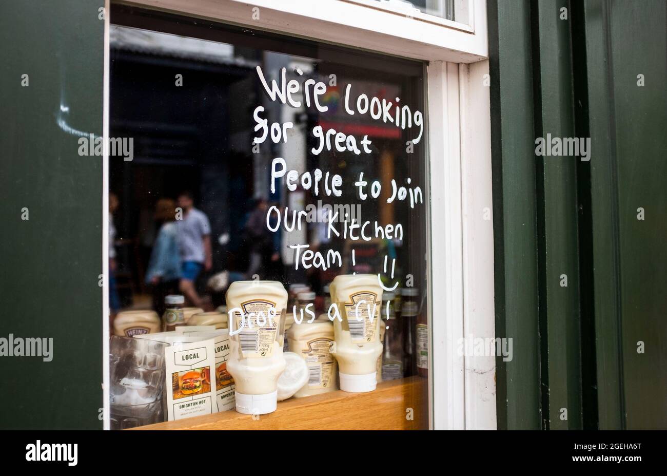 Brighton, UK. 20th Aug, 2021. Staff Wanted signs as Brighton shops and restaurants are busy during the summer holidays in Britain . Some businesses in the UK have been struggling to find enough staff since the lockdown restrictions have been eased : Credit Simon Dack/Alamy Live News Stock Photo
