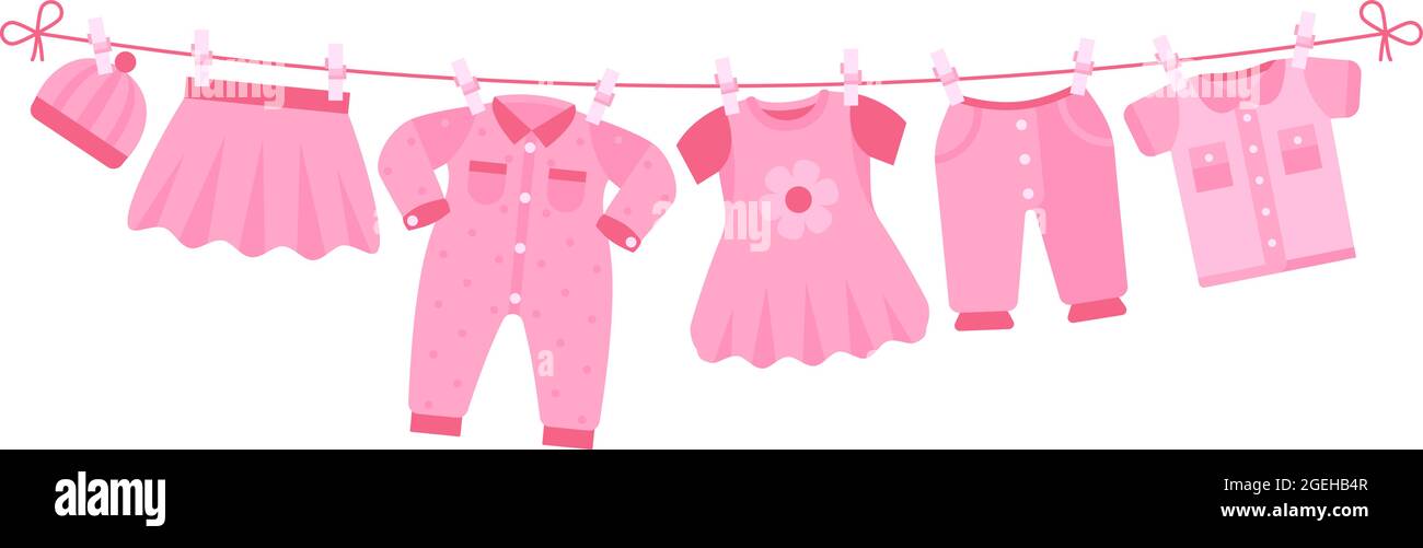 Girl newborn clothes. Cute pink dress, hat pants drying on clothesline