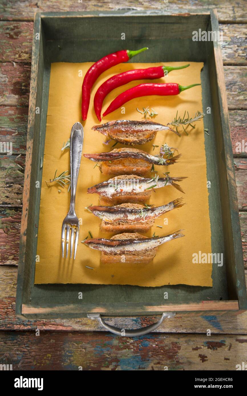 Presentation of a snack based on chili anchovies and wholemeal bread Stock Photo Alamy