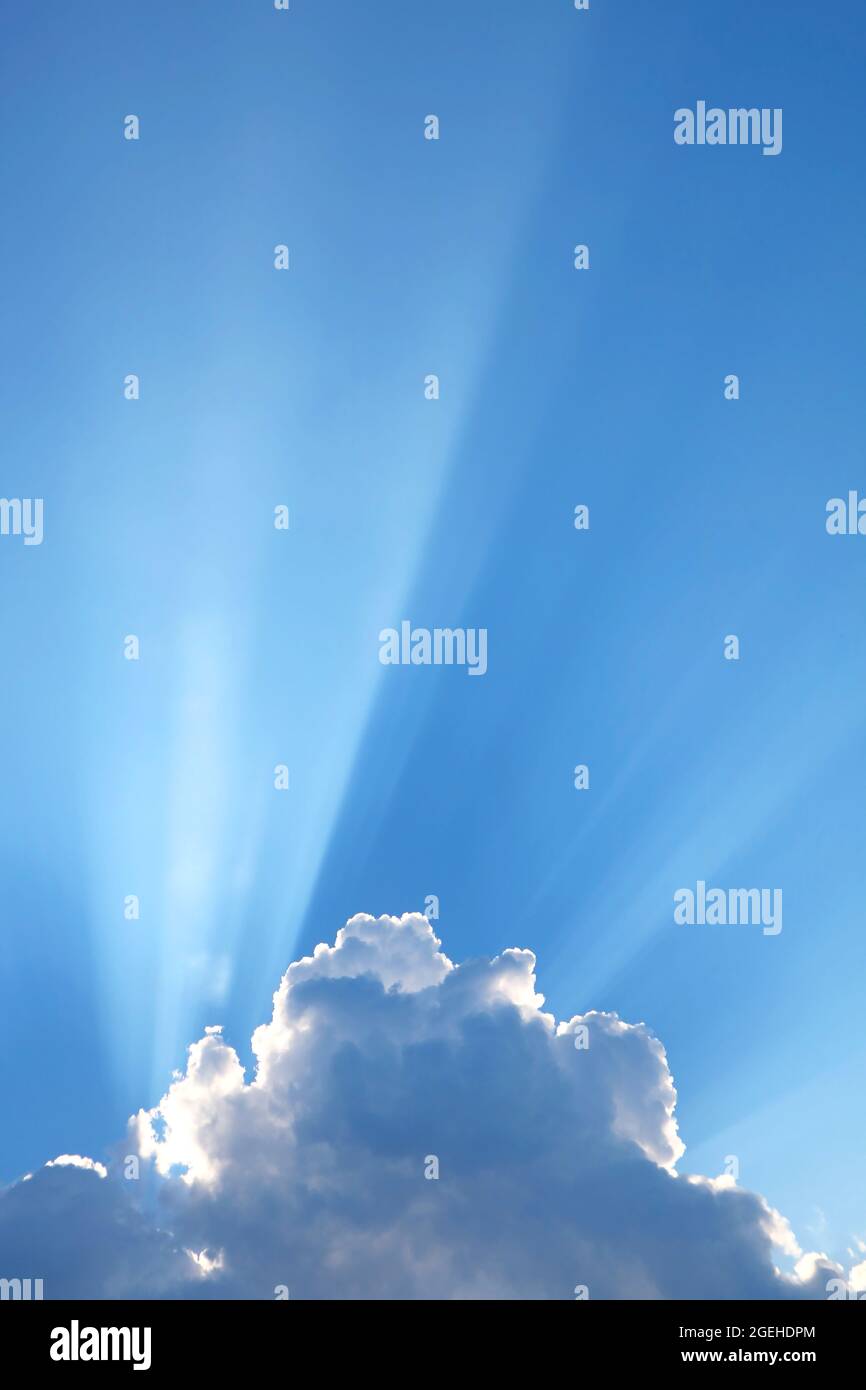 Incredible Sunbeam Shining Through the Fluffy Clouds Stock Photo