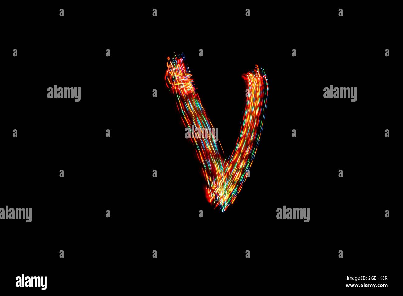 Letter V. Light painting alphabet. Long exposure photography. Drawing
