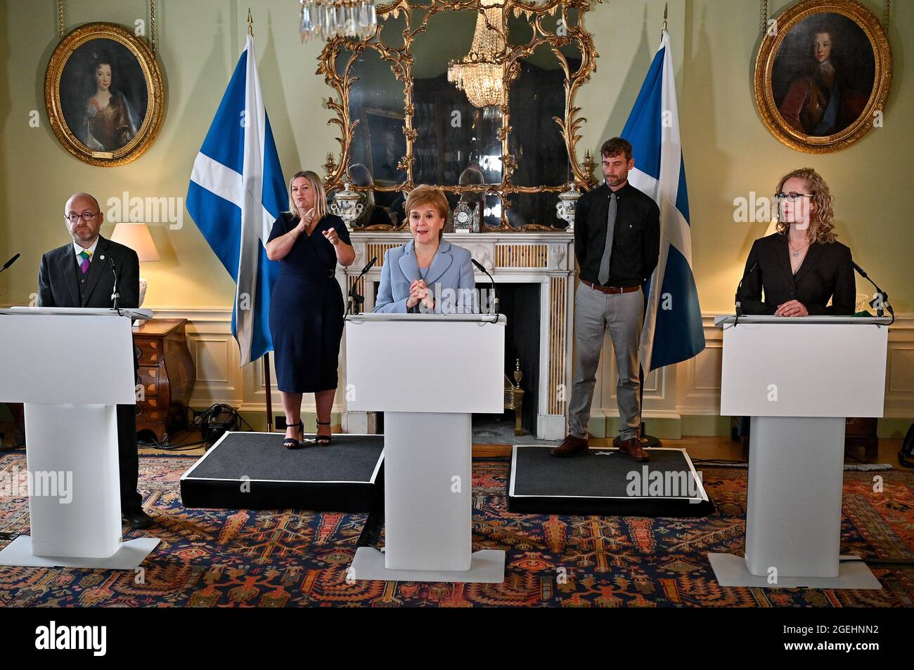 First Minister Nicola Sturgeon (centre) and Scottish Green Party co-leaders Patrick Harvie (left) and Lorna Slater (right) at Bute House, Edinburgh, after the finalisation of an agreement between the SNP and the Scottish Greens to share power in Scotland. The two parties have been locked in negotiations since May, after the SNP fell one seat short of an overall majority at the Holyrood election. Picture date: Friday August 20, 2021. Stock Photo