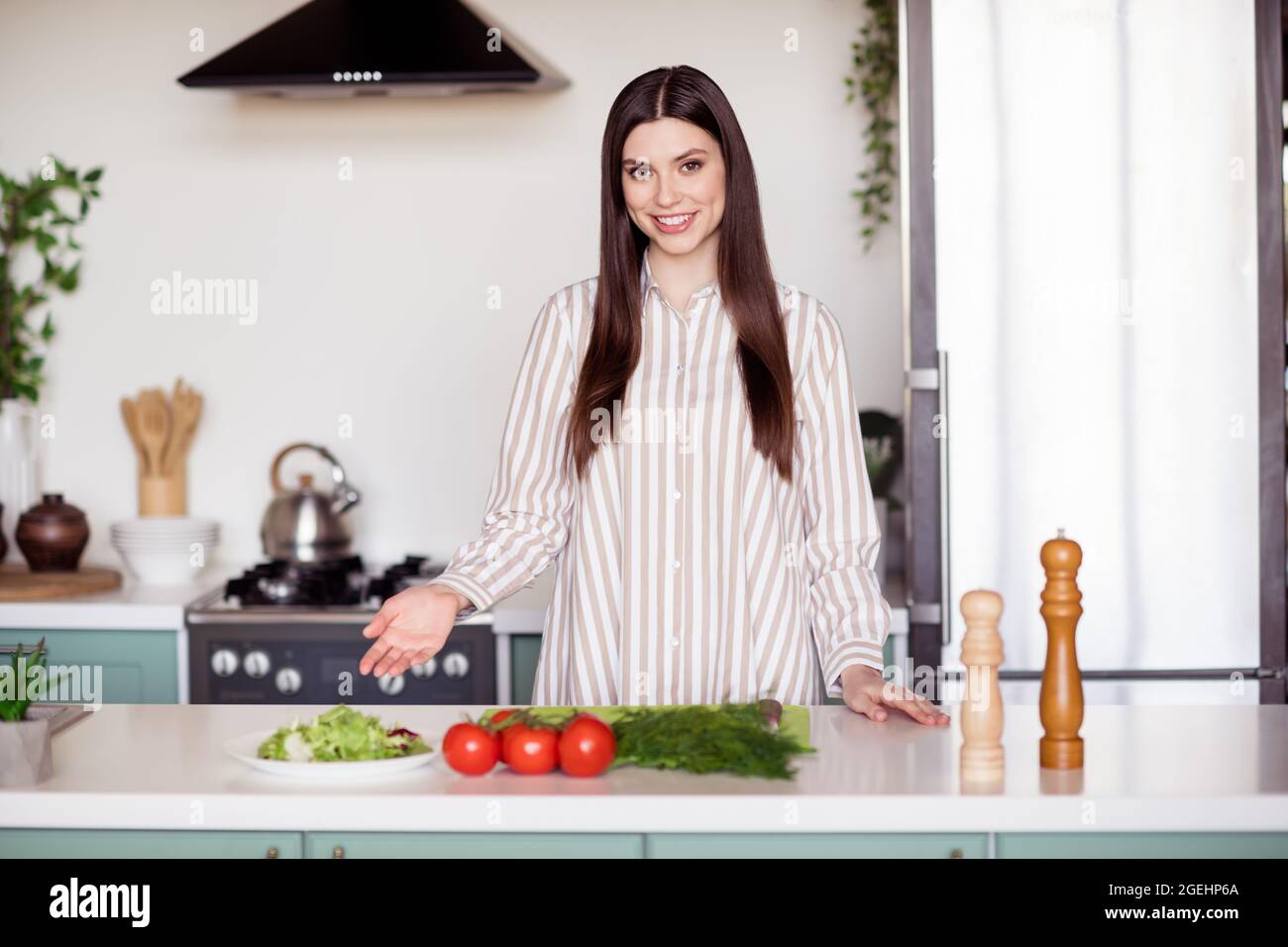 Photo of nice millennial lady cook dish wear white shirt at home kitchen alone Stock Photo