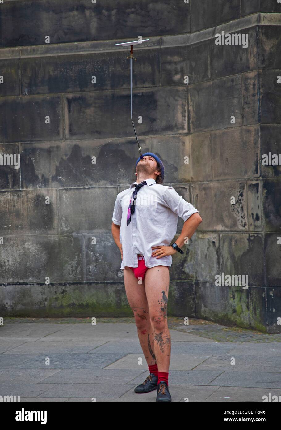 Edinburgh, Scotland, UK weather. 20 August 2021. Cloudy day for city centre and those seeking some enterainment from the various festivals in the city. Pictured: Timon street performer with his balancing act. Credit: Arch White/Alamy Live News Stock Photo
