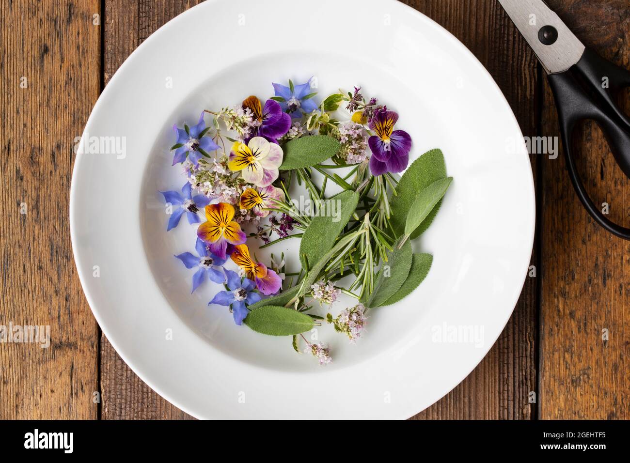 Red Herbal Tea with Edible Flowers. Organic Beverage Stock Photo - Alamy