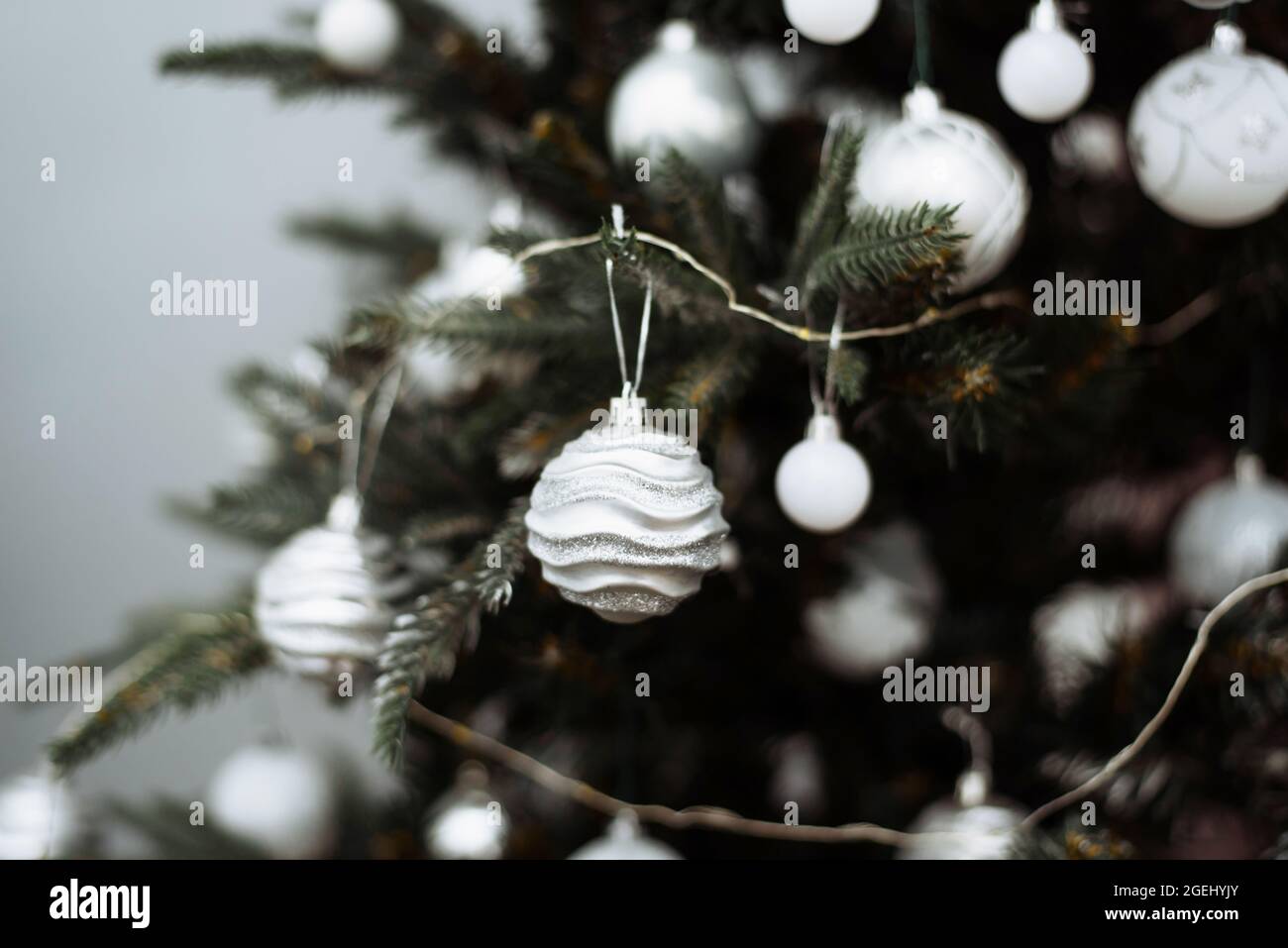 Christmas tree branch decorated with silver balls and white garland ...
