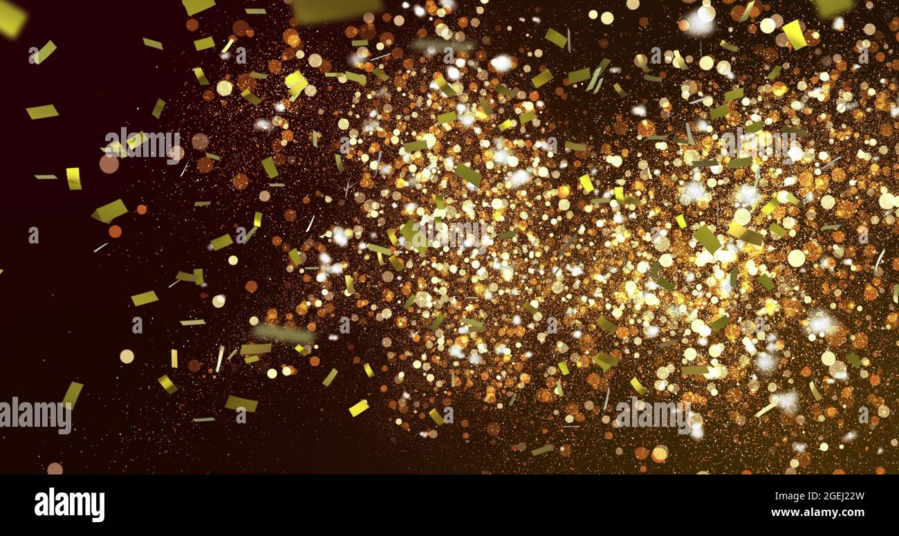 Image of gold confetti falling over glowing golden spots in the ...