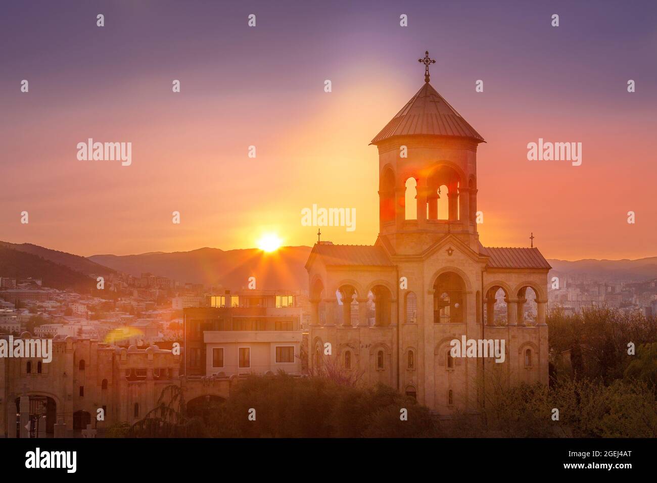 Bell tower of Holy Trinity church or Tsminda Sameba Cathedral sunset ...