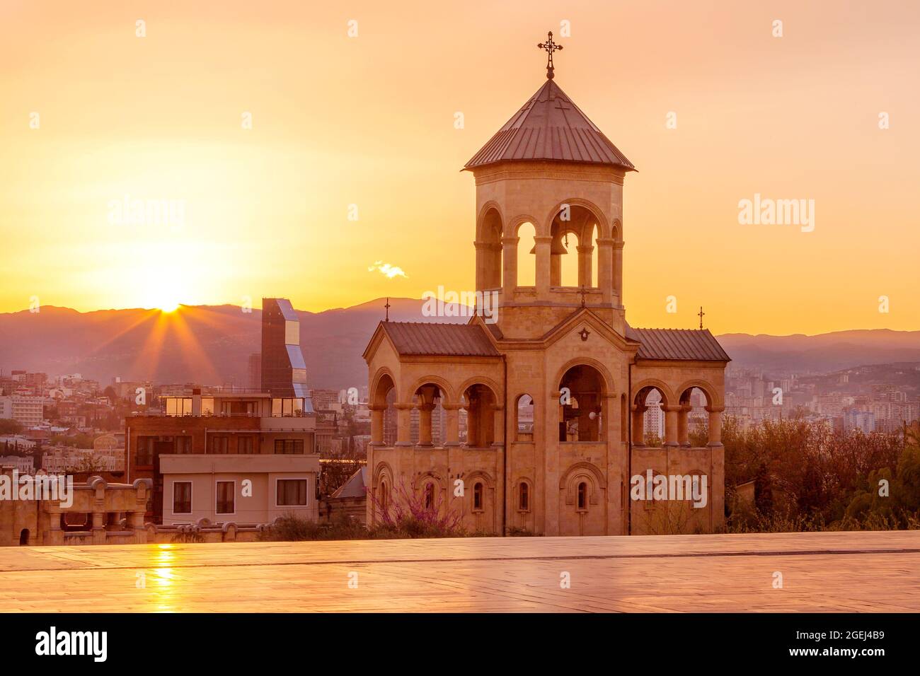 Bell tower of Holy Trinity church or Tsminda Sameba Cathedral sunset ...