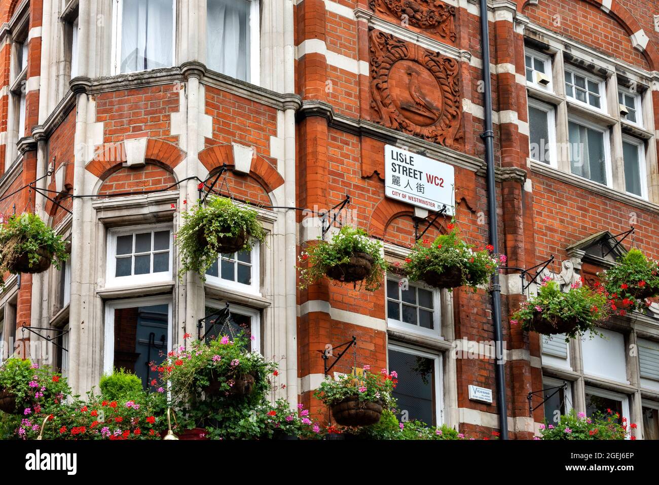 LONDON LISLE STREET CHINATOWN BUILDING WITH HANGING FLOWER BASKETS AND
