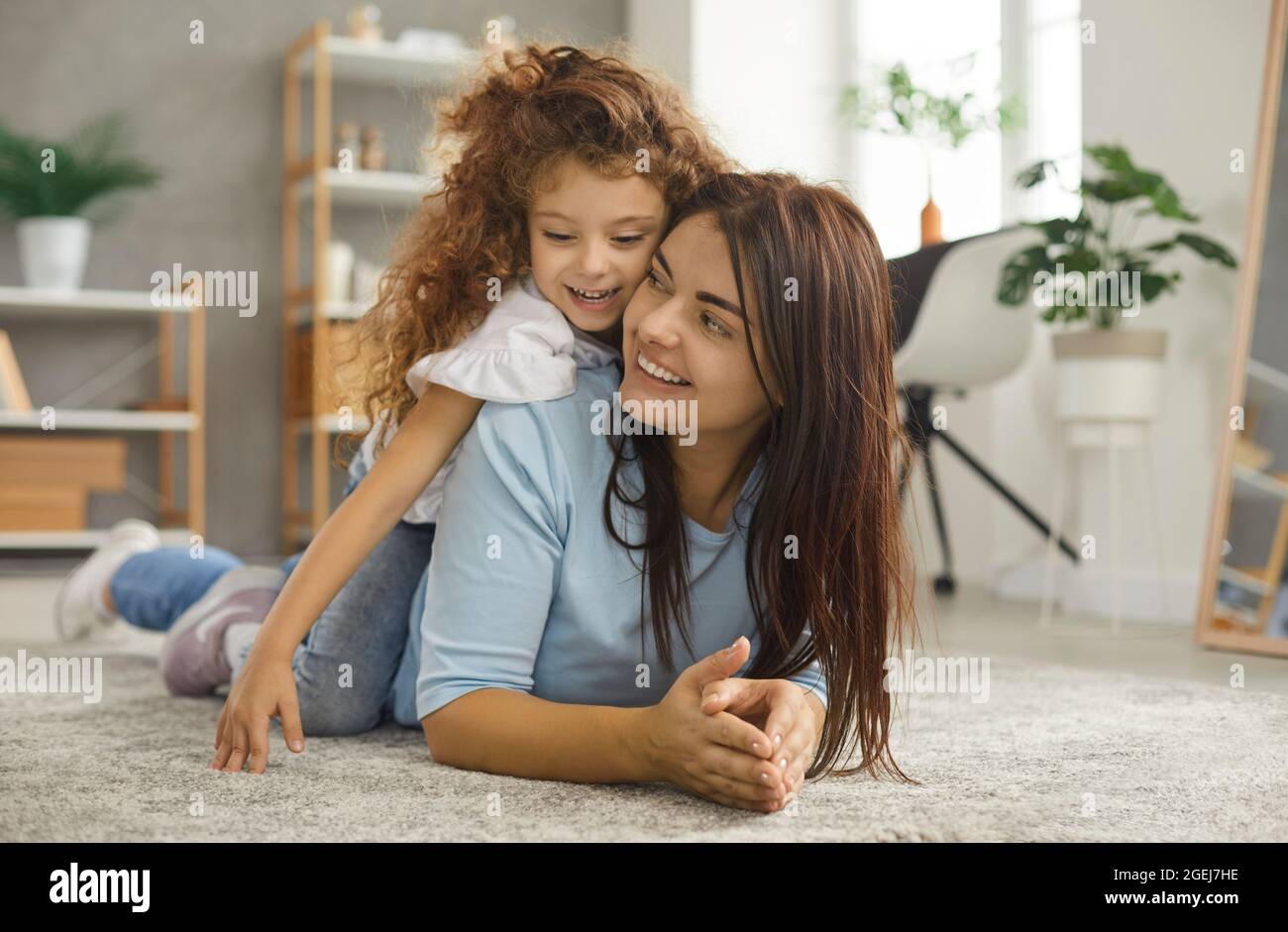 Happy mother play at home with teen daughter Stock Photo