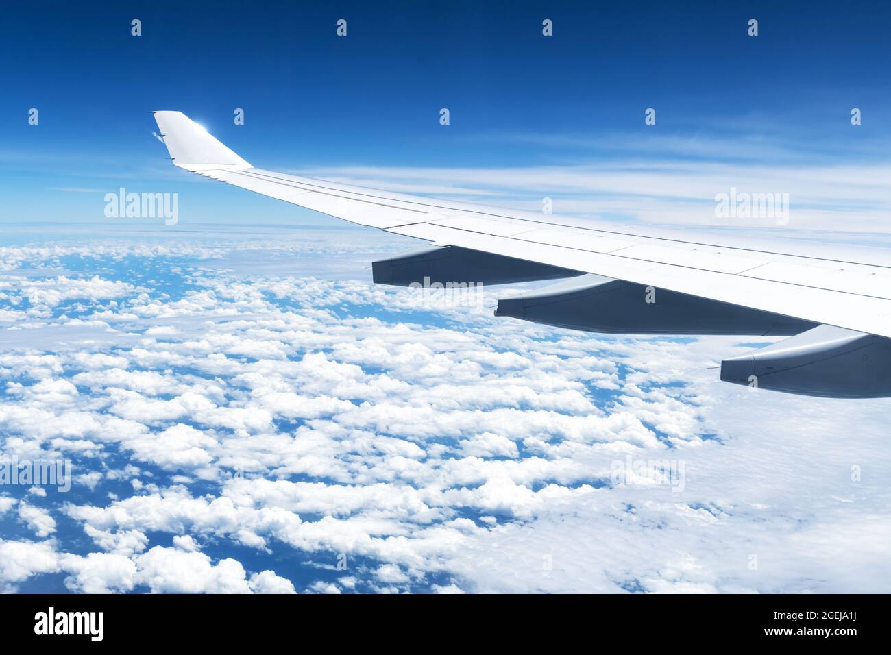 View of clouds and wing from a plane window. Travel and vacations concept Stock Photo