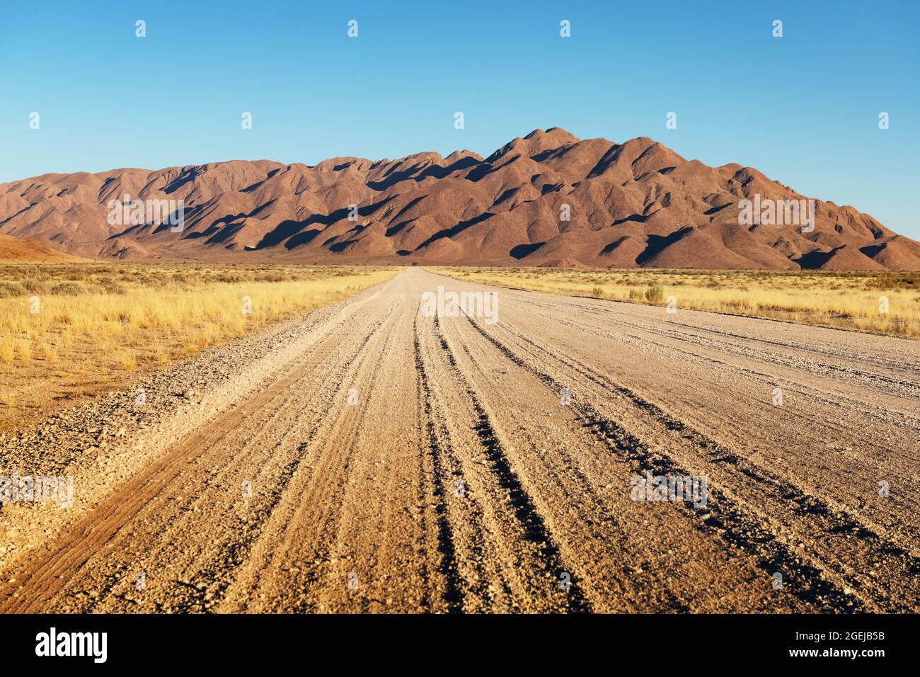 Gravel road and beautiful landscape with sunset sky in Namibia, Africa Stock Photo