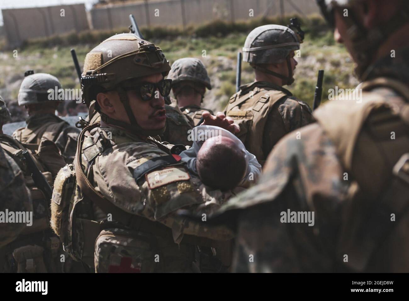 Kabul, Afghanistan. 20th Aug, 2021. An Airmen comforts an infant during an evacuation at Hamid Karzai International Airport, in Kabul, Afghanistan, August 20, 2021. U.S. service members and coalition partners are assisting the Department of State with a Non-combatant Evacuation Operation (NEO) in Afghanistan. Photo by Sgt. Isaiah Campbell/USMC/UPI Credit: UPI/Alamy Live News Stock Photo