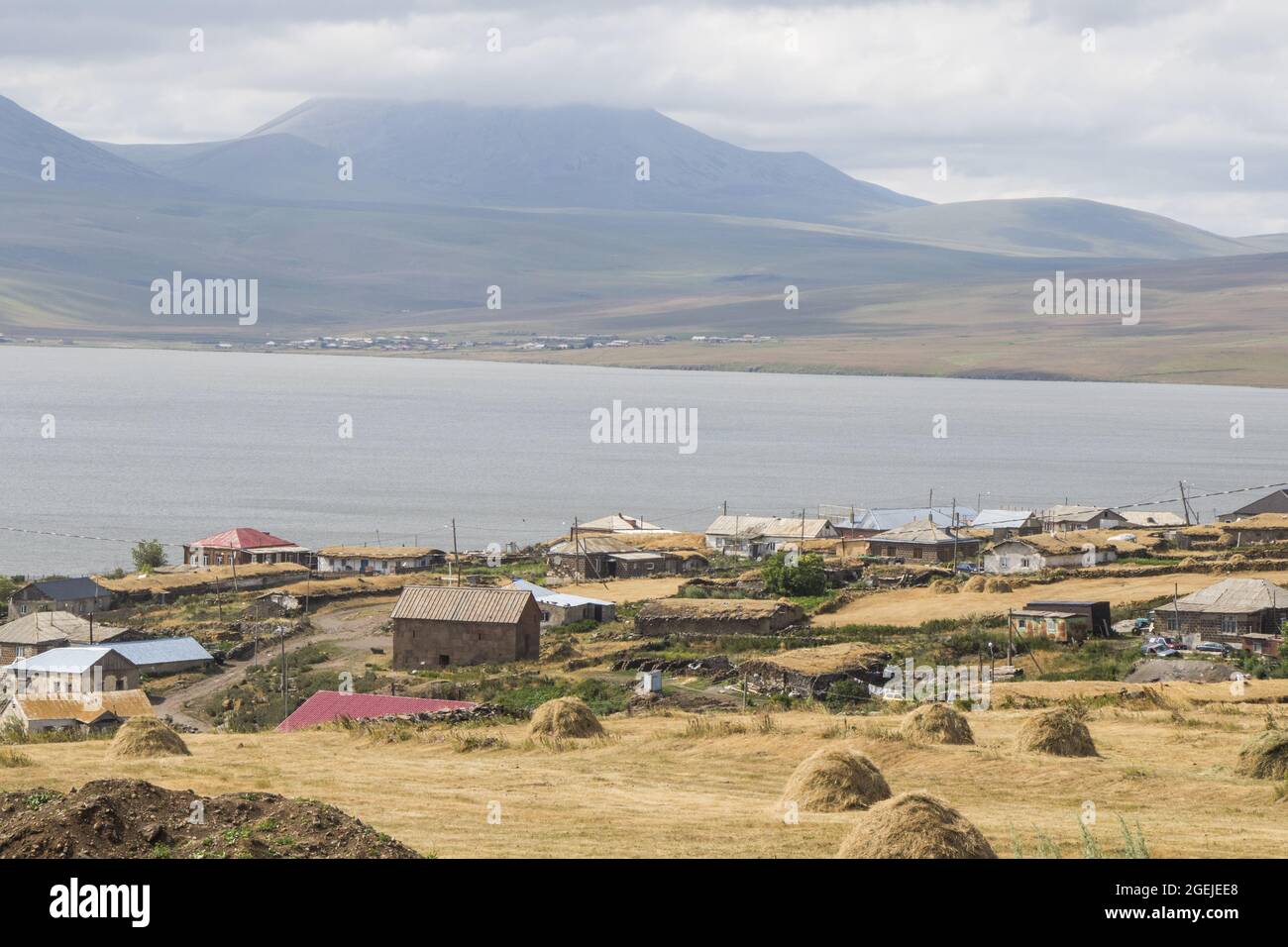 View of village houses and a farm on the shores of Lake Paravani, in ...