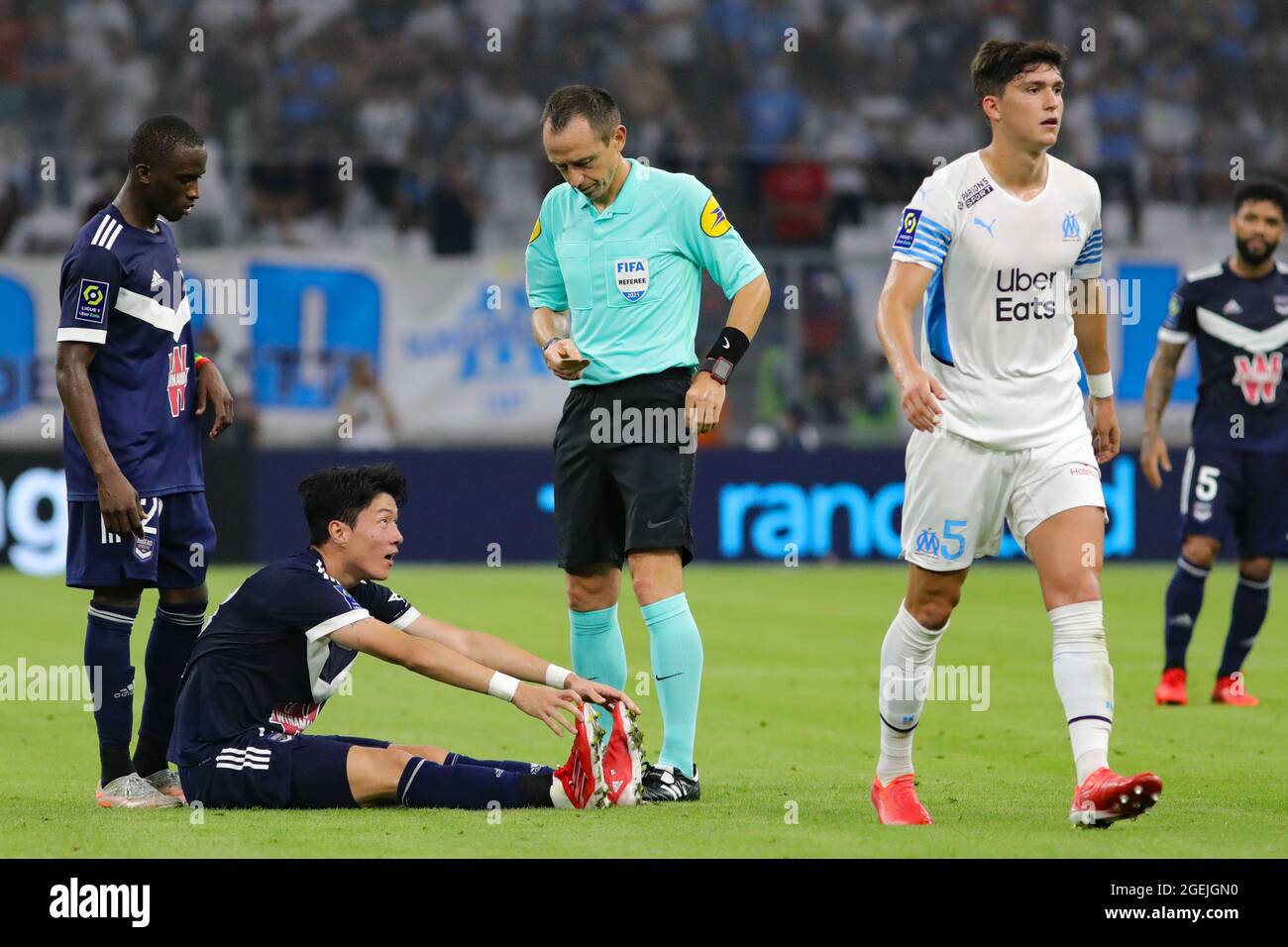 Ui Jo Hwang of Bordeaux is lying on the pitch after being tackled 