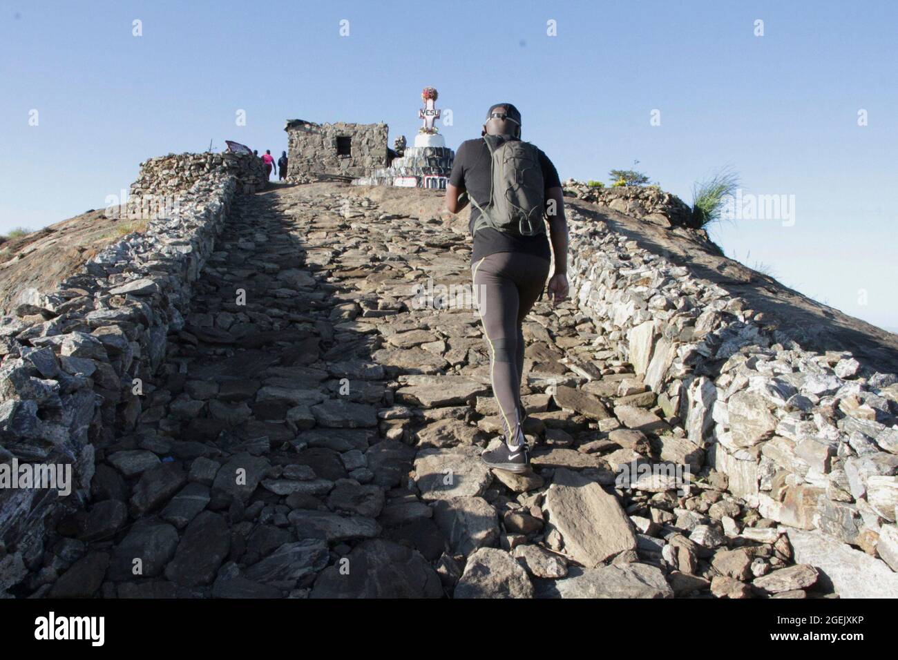 A man is seen walking on the path to the peak of Bunda mountain, which is  neatly laid with stones creating a wall on either side. Malawi Stock Photo  - Alamy