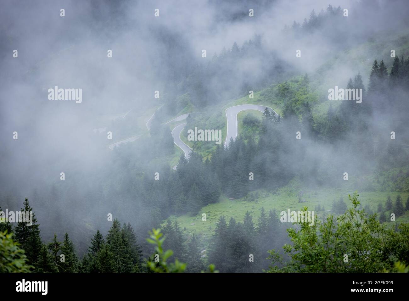 A rainy day in the Austrian Alps with deep clouds and fog Stock Photo ...