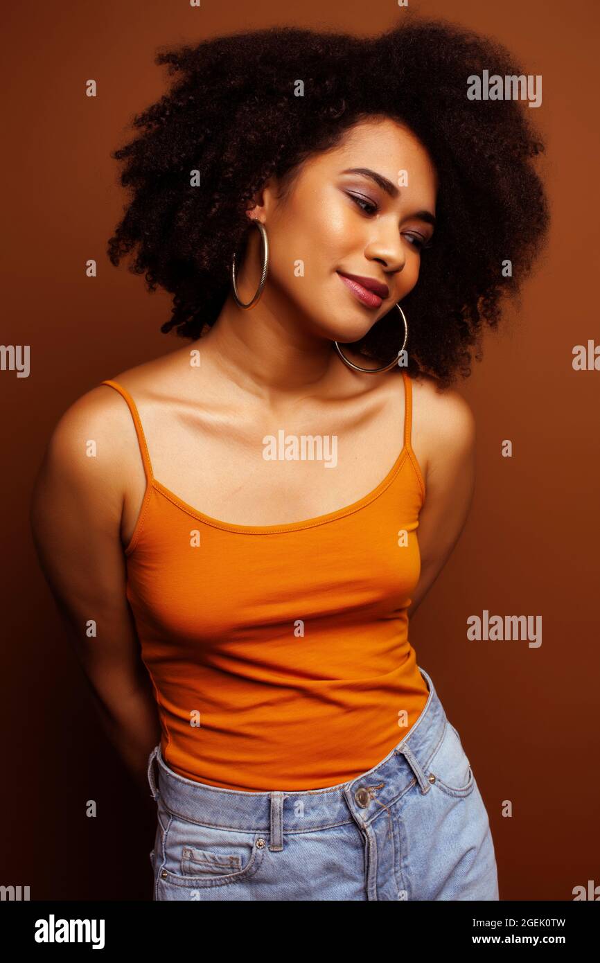 pretty young african american woman with curly hair posing cheerful ...