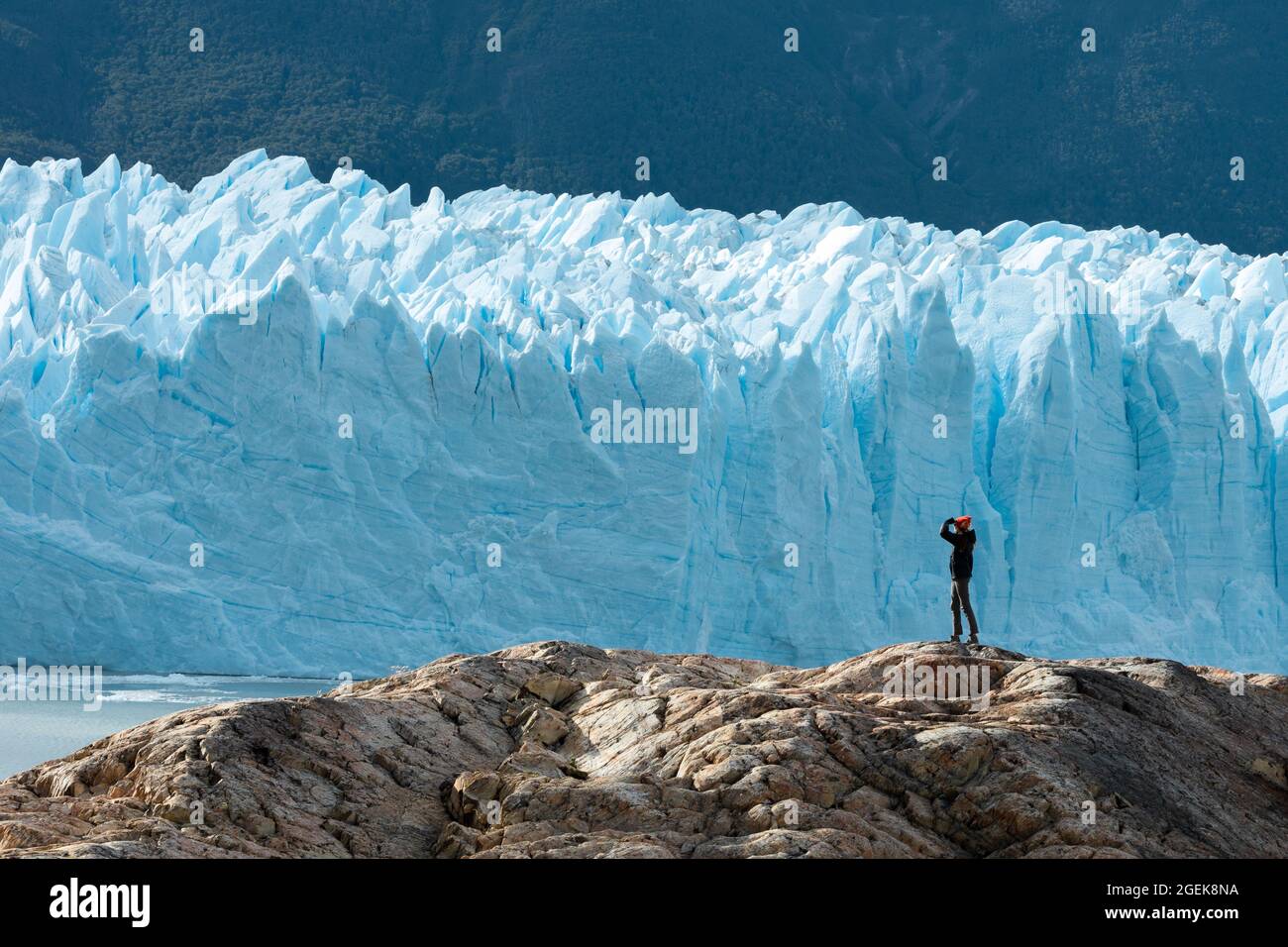 A woman on the rock, Perito Moreno Glacier Stock Photo