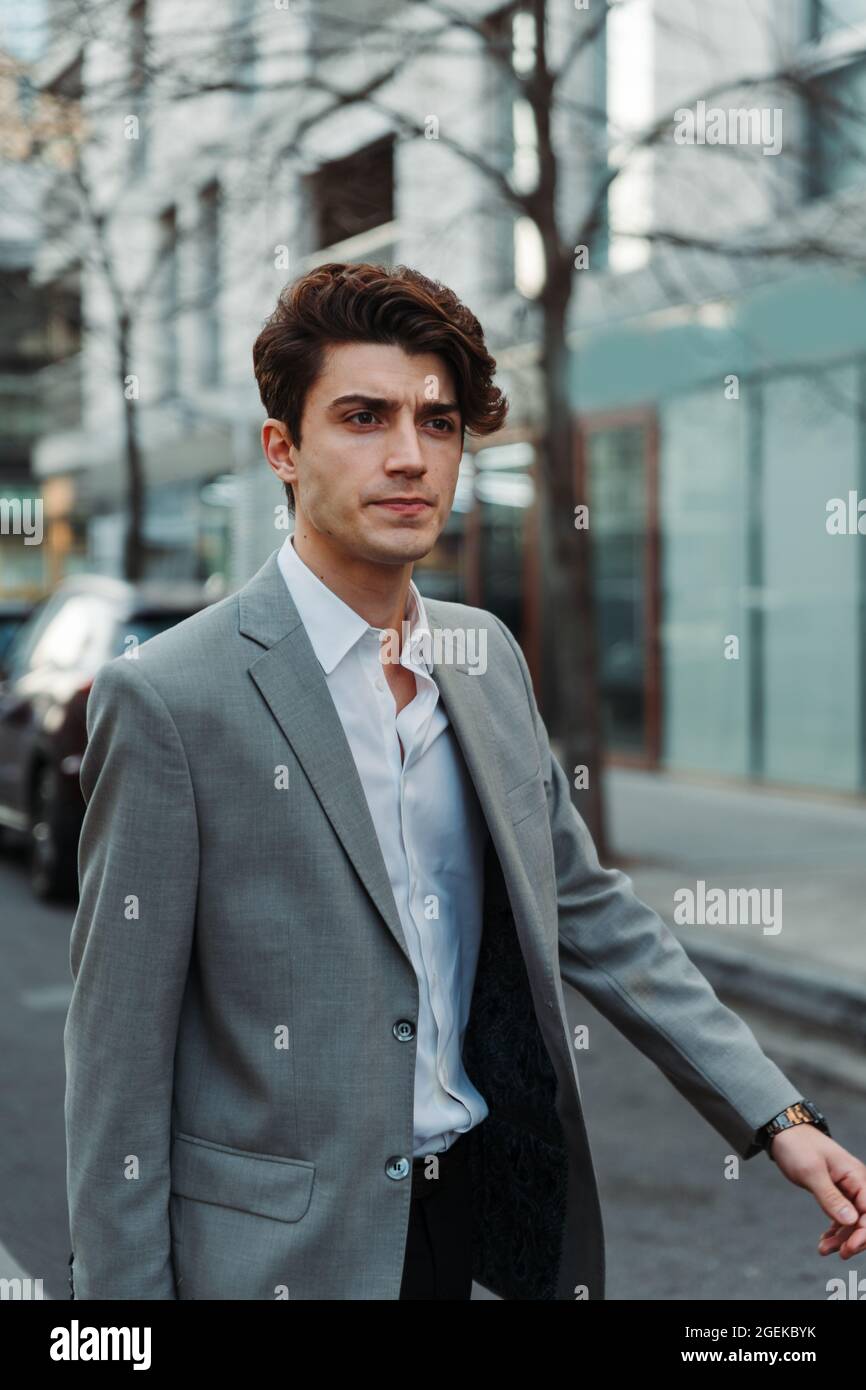 Walking young man in suit hi-res stock photography and images - Alamy