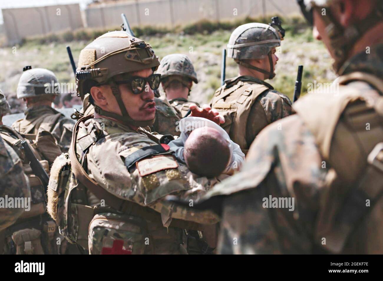 Kabul, Afghanistan. 20th Aug, 2021. A U.S. soldier comforts an infant as he is taken to safety during the evacuation of non-combatants at Hamid Karzai International Airport, part of Operation Allies Refuge August 20, 2021 in Kabul, Afghanistan. Credit: Planetpix/Alamy Live News Stock Photo