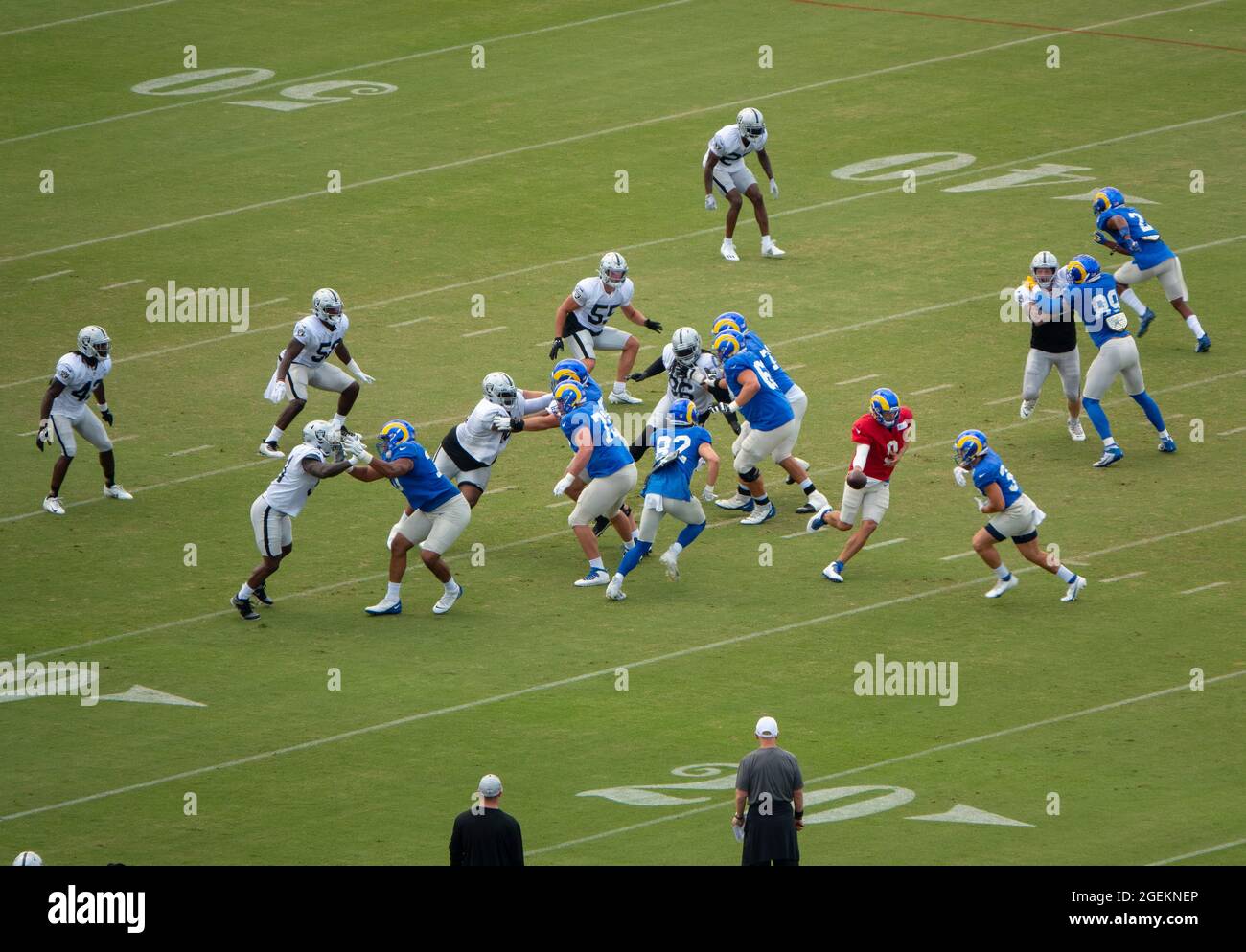 Thousand Oaks, California, USA. 19th Aug, 2021. The Los Angeles Rams and the Las Vegas Raiders held a joint practice at the Rams training facility at California Lutheran University. Here, Rams quarterback Matthew Stafford, in red jersey, hands off to Jake Funk. (Credit Image: © K.C. Alfred/ZUMA Press Wire) Stock Photo