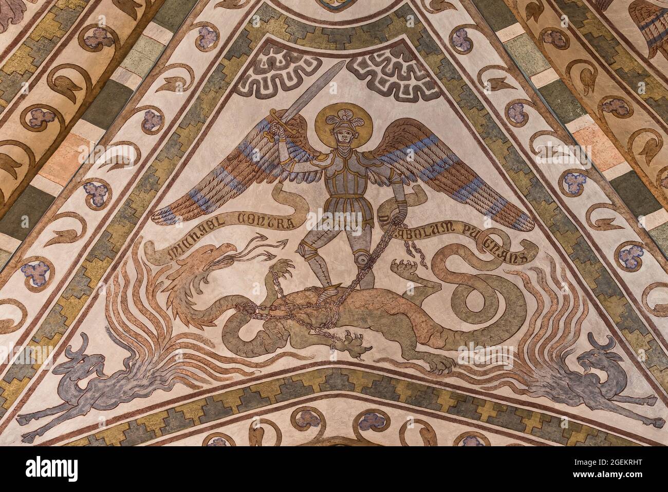 the archangel michael in armor lifts his sword and kills the dragon, fresco from the 1300s in St. Kopinge church, Sweden, July 16, 2021 Stock Photo