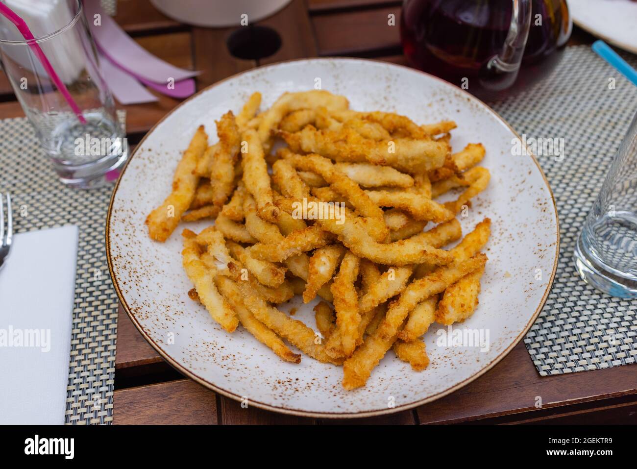 French fries with powder cheese and mayonnaise sauce serve on black plate for food background or