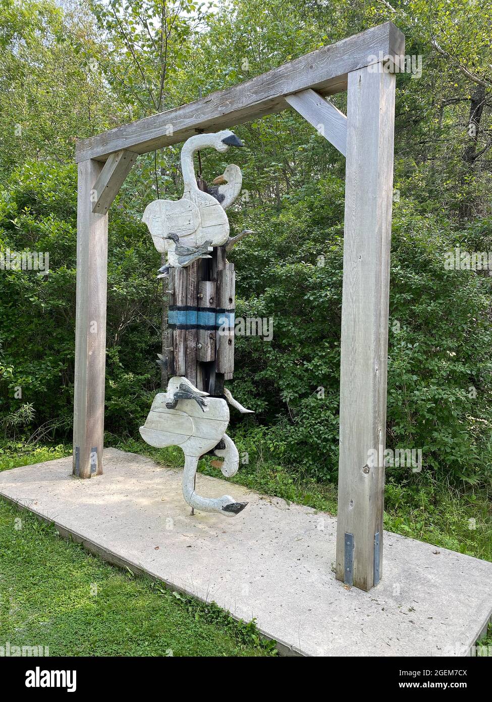 This sculpture, titled Reflection (seagulls on pilings with blue line representing water), was done by American artist Bernard Langlais and is housed at the Langlais Sculpture Preserve in Cushing, Maine. Bernard Langlais (1921 - 1977) was a Maine native and maintained a studio in Cushing, Maine until his death at the age of 56. He developed his artistic interest at the Corcoran School of Art in Washington DC and the Skowhegan School of Painting and Sculpture. Stock Photo