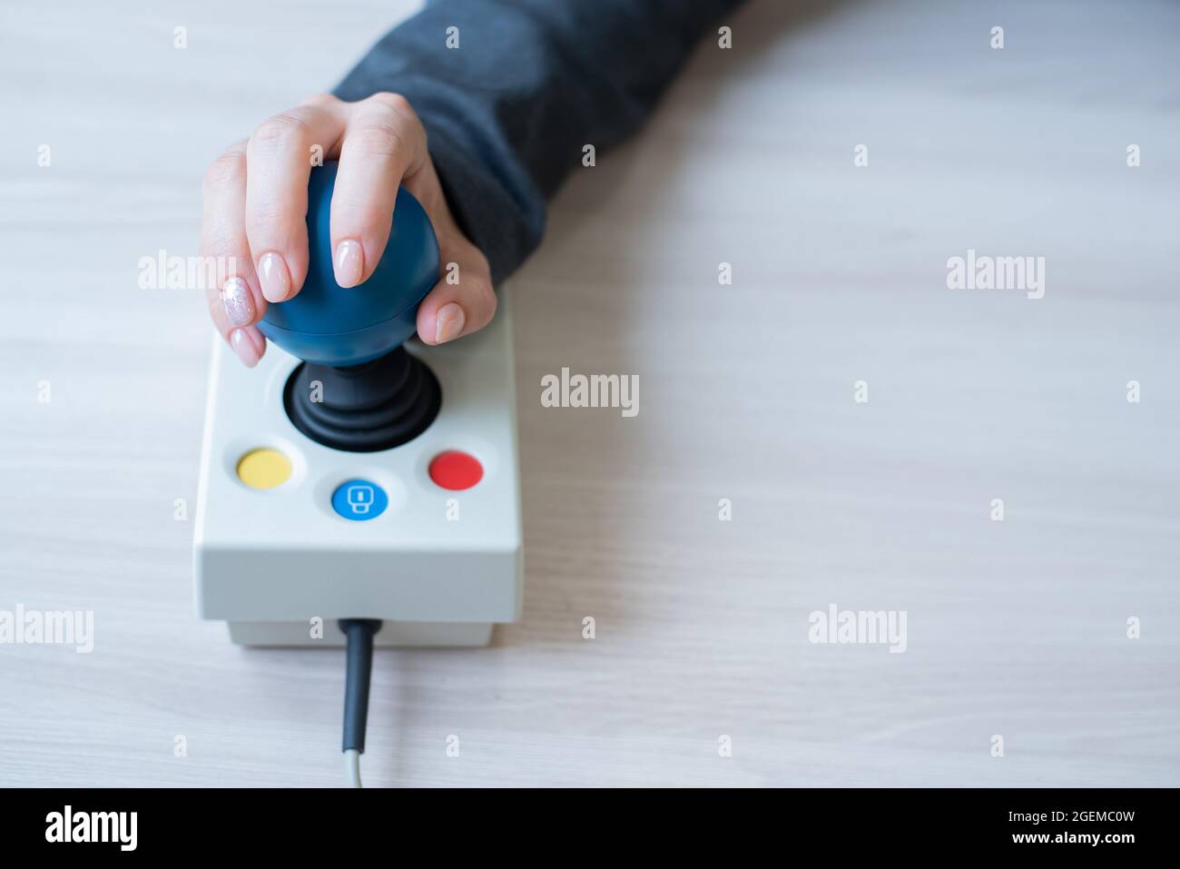 Woman with cerebral palsy works on a specialized computer mouse Stock Photo  - Alamy