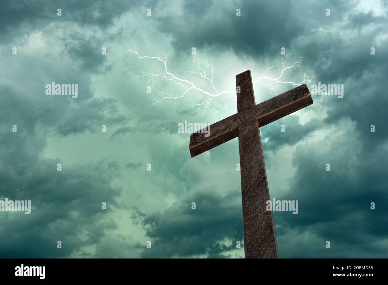 Dramatic image showing a religious church cross framed against a sky of lightning, bright light and sun rays, showing the coming of the Lord.  Copy sp Stock Photo