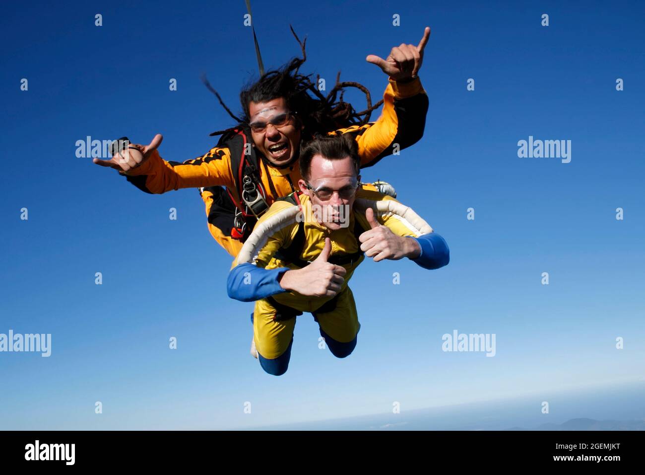 July 12, 2009. Porto Belo, Santa Catarina, Brazil. A dreadlocked instructor and a student jump tandem parachute in bliss. Stock Photo