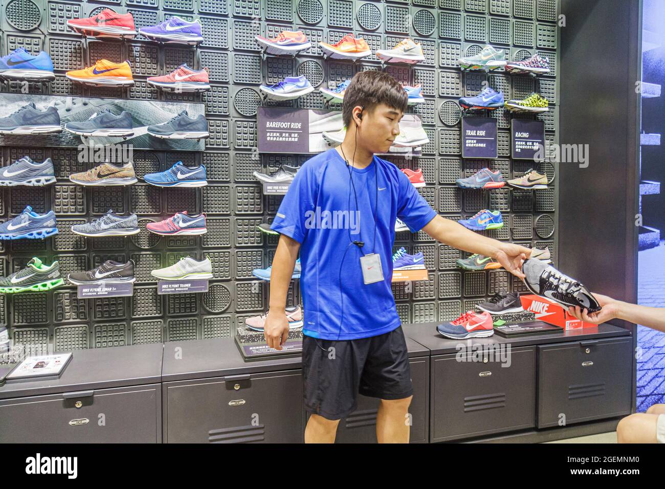 Beijing China,Chinese,Chaoyang District Sanlitun Village South North Piazza  Deck,shopping shop business Nike Store athletic shoes,Asian man male emplo  Stock Photo - Alamy