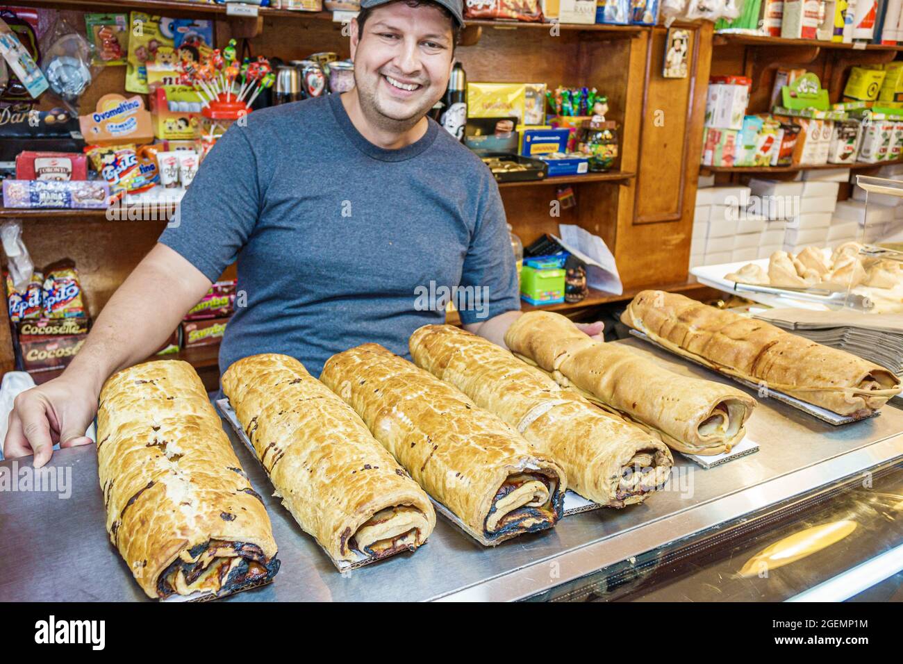Miami Beach Florida,Charlotte Bakery Venezuelan interior inside,Hispanic man employee worker pan de jamon ham bread Christmas, Stock Photo