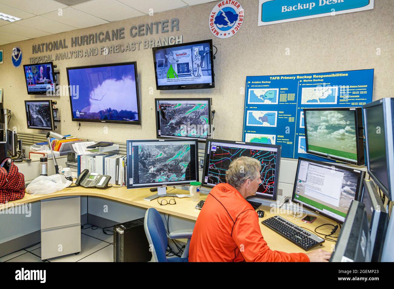 Miami Florida,National Hurricane Center NHC NOAA National Weather Service,interior inside forecast desk,meteorologist man male computer screen monitor Stock Photo