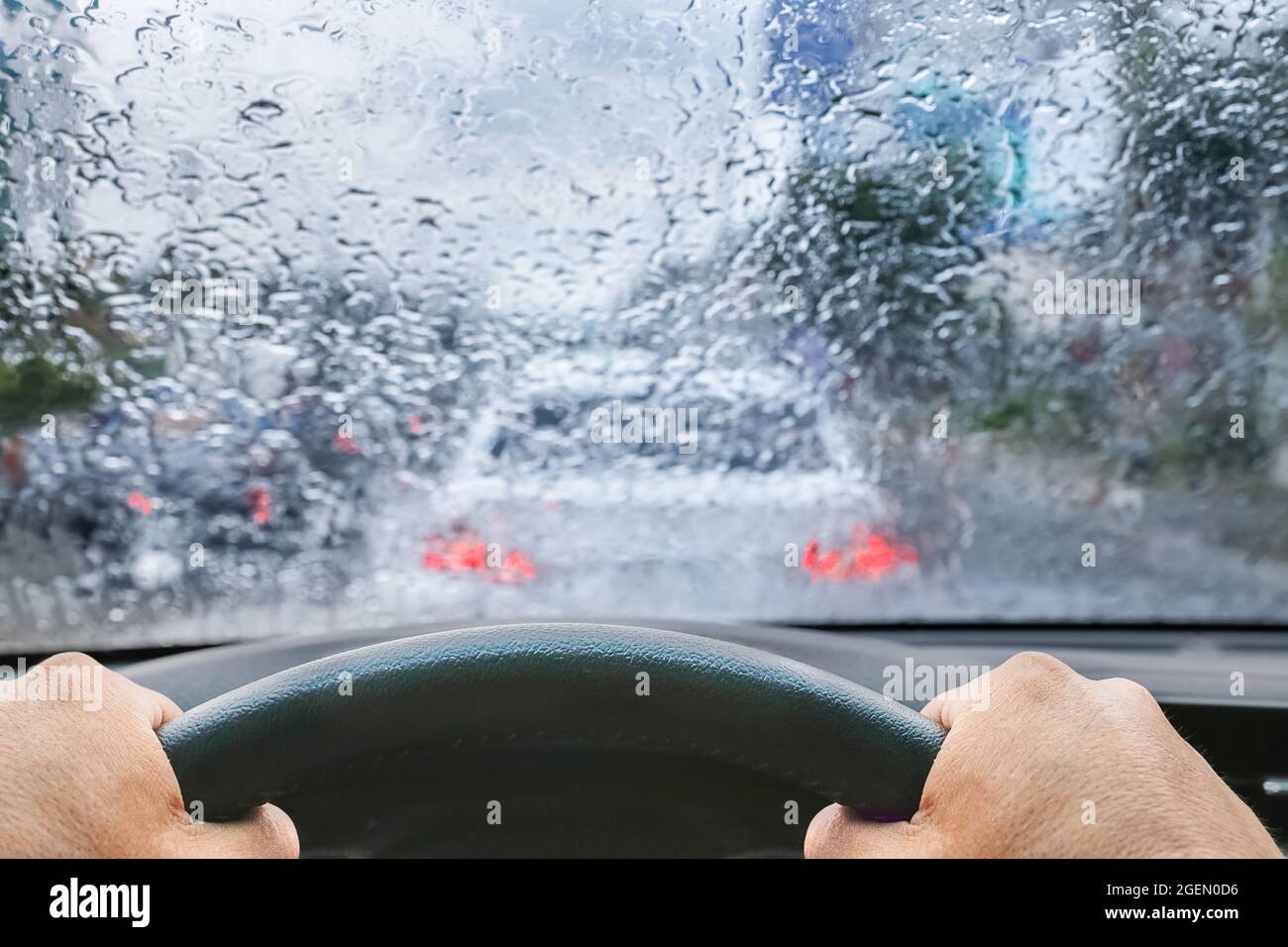 Raindrops on windshield from inside the car in traffic jam Stock Photo