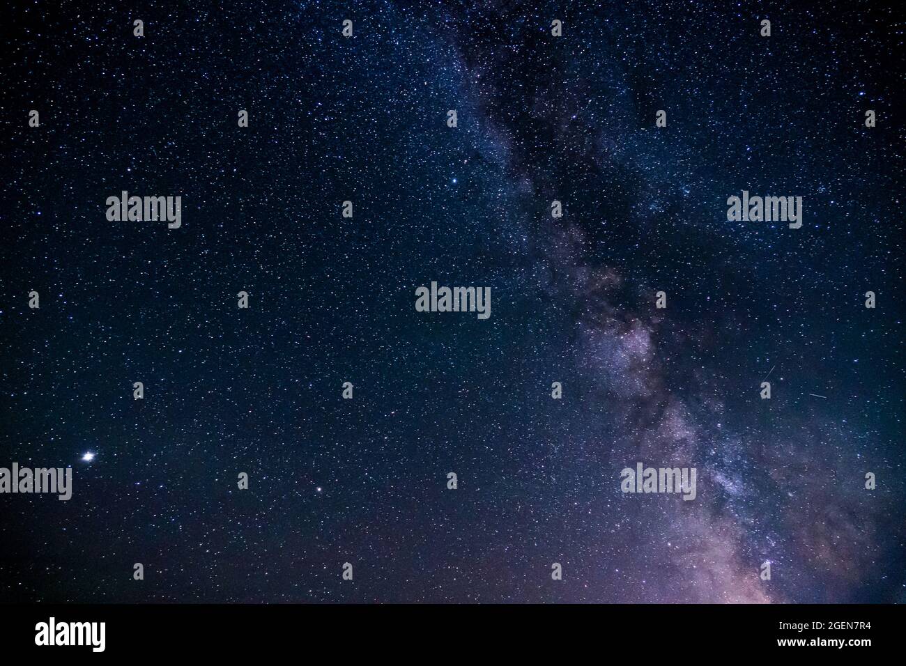 Night sky filled with galaxy stars dark blue space background. Stock Photo