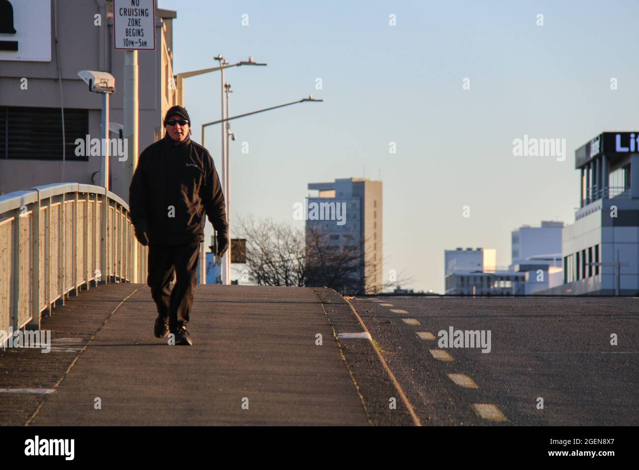 A man gets some early morning exercise on an empty street.New Zealand's outbreak of the Delta variant has so far seen 28 confirmed cases in Auckland, and three in Wellington. Prime Minister Jacinda Ardern yesterday placed areas outside Auckland and Coromandel into a further lockdown until 11.59 pm on Tuesday. Deputy Prime Minister Grant Robertson said this morning, “things will get worse before they get better”, and that “there will be more cases”. He said he hadn't yet had the update on today's numbers, but that information would be given at the 1 PM NZ time, press conference. More than 40, 0 Stock Photo