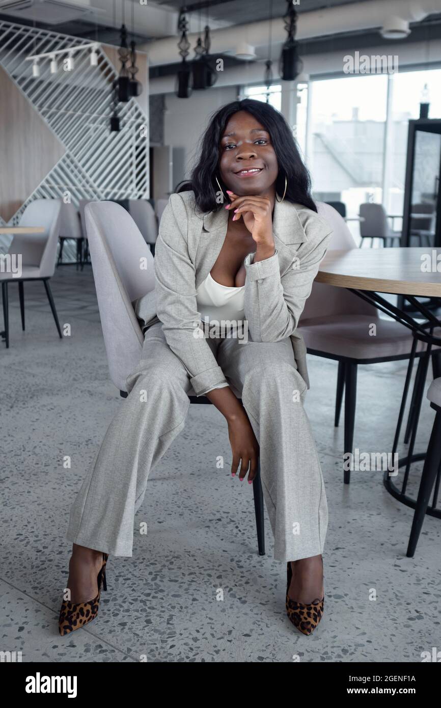 young african american woman in business suit sits on a chair Stock ...