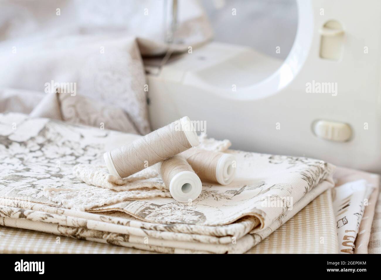 Threads, fabrics and sewing machine. Hobby time Stock Photo - Alamy