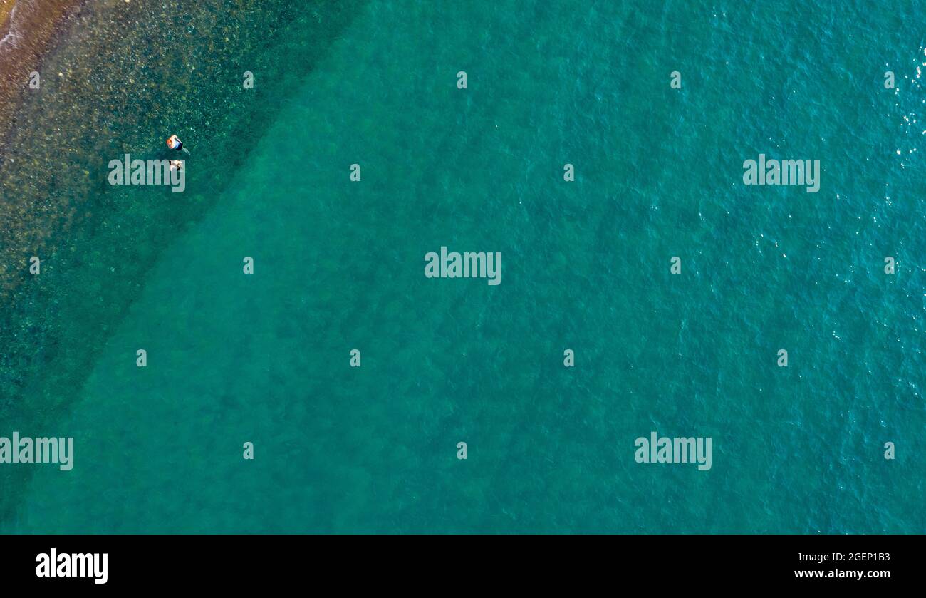 Aerial view from flying drone of blue ocean water with unrecognized ...