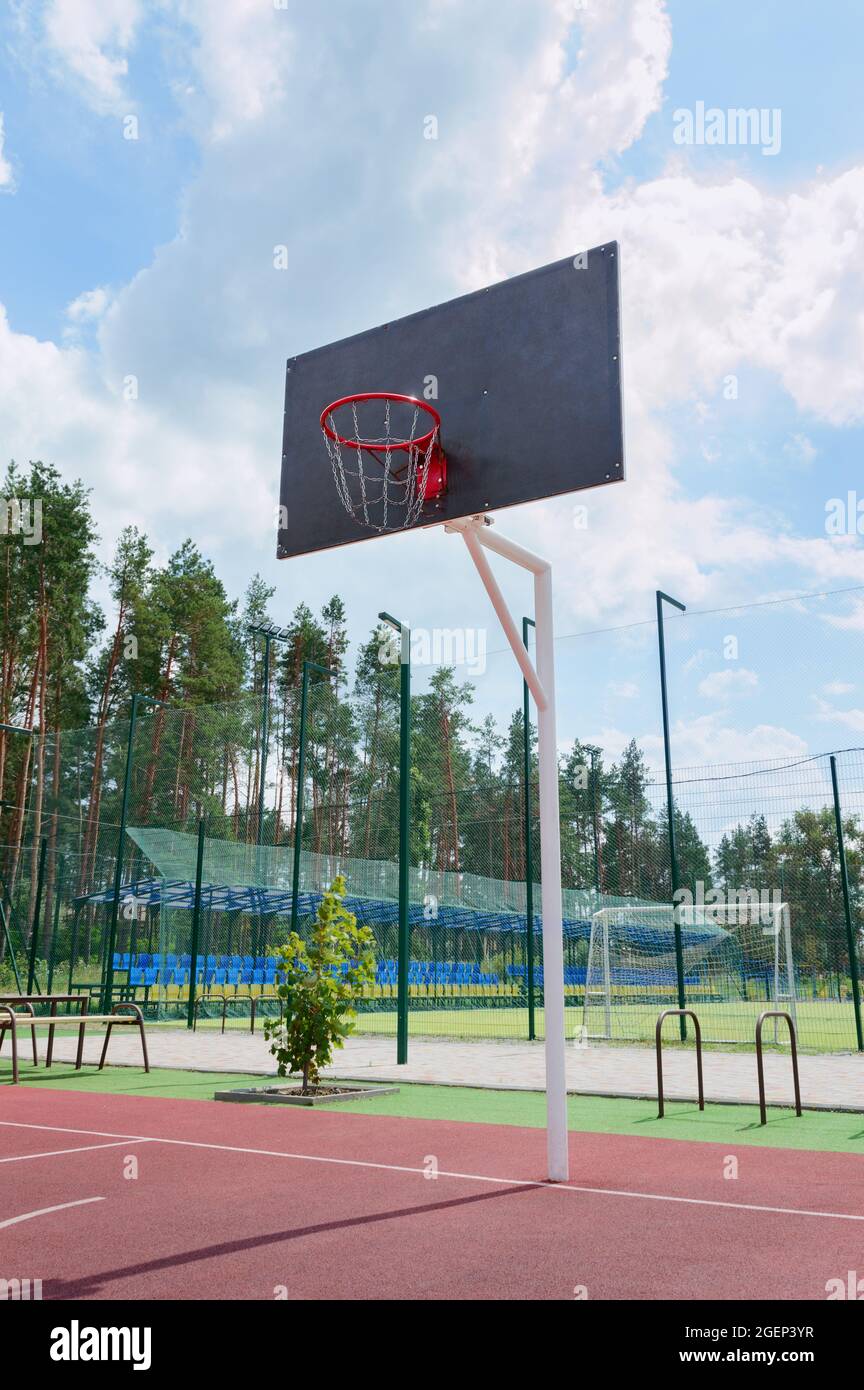 Street sport concept. Basketball backboard with a basket made of iron chains on a sunny day. Vertical view. Low angle view Stock Photo