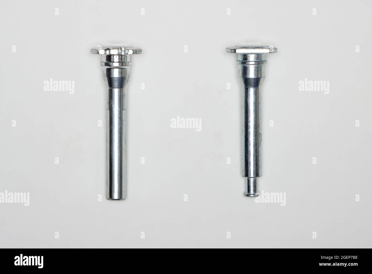 Two metal fingers, machine repair parts. A set of spare parts for servicing the braking system of a vehicle. Details on white background, copy space available. Stock Photo